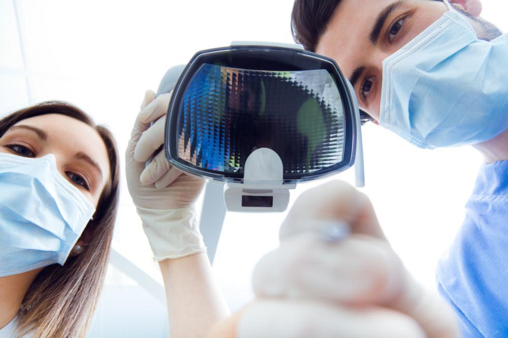 dentist looking down at camera | sedation dentistry irvine ca
