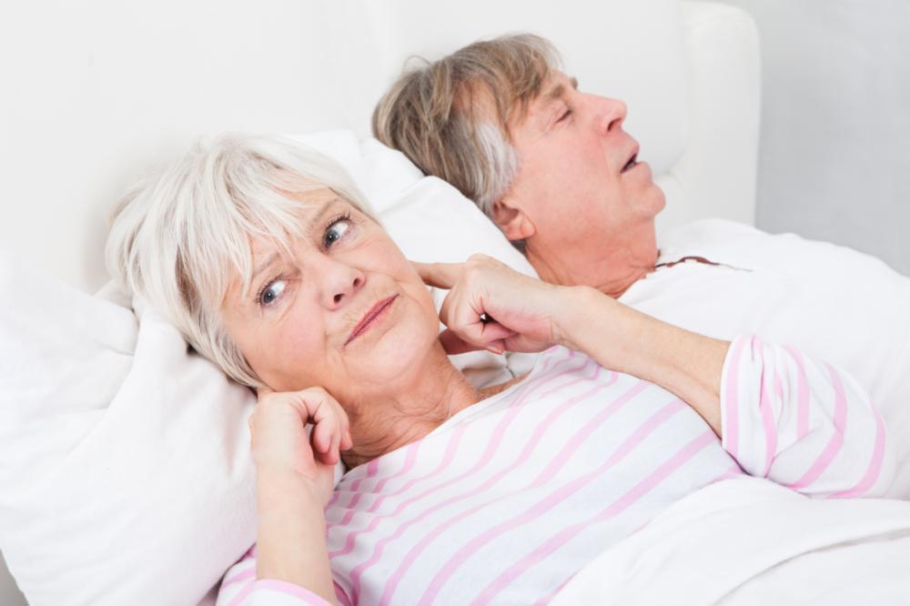 woman plugging her ears from her husband snoring | sleep apnea treatment irvine ca