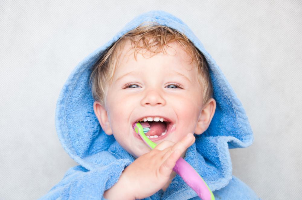 kid smiling with toothbrush in irvine