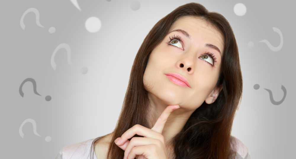 woman looking pensive with question marks around her