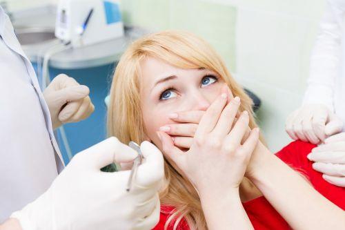 irvine woman hiding mouth from dental anxiety