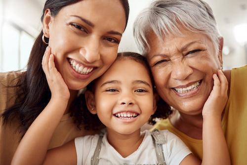 mother, grandmother, and granddaughter smiling