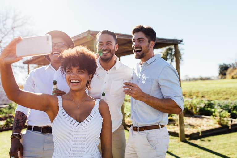 group of friends taking a selfie while at a winery
