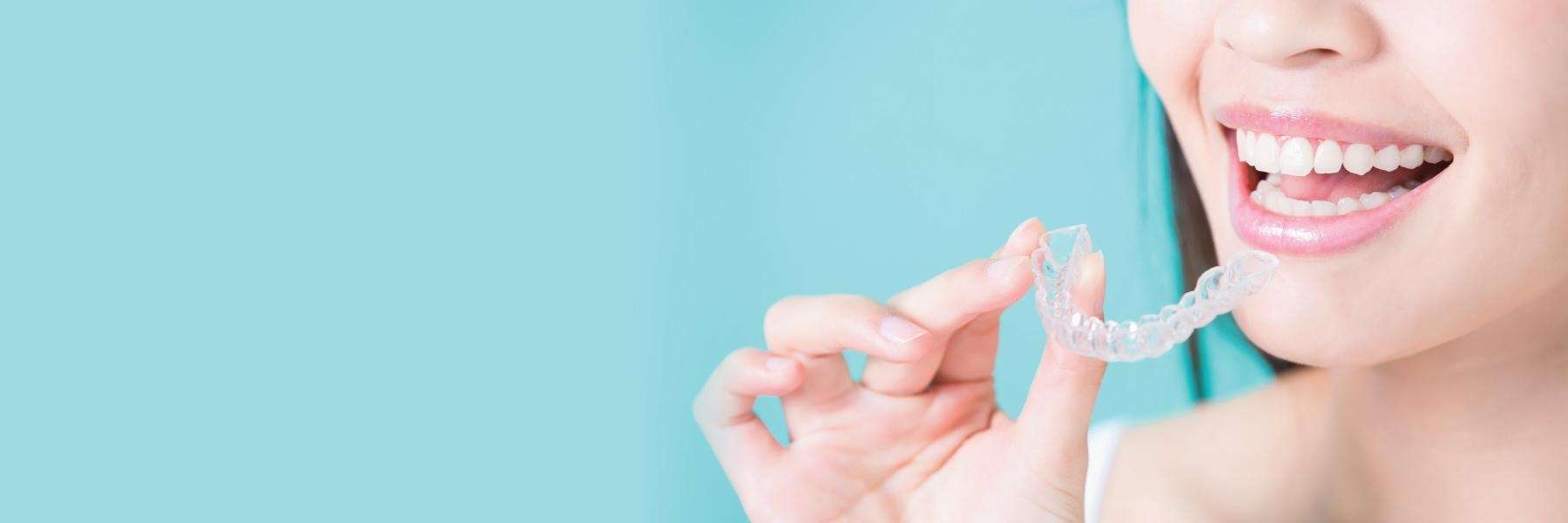 woman holding Invisalign aligners in irvine
