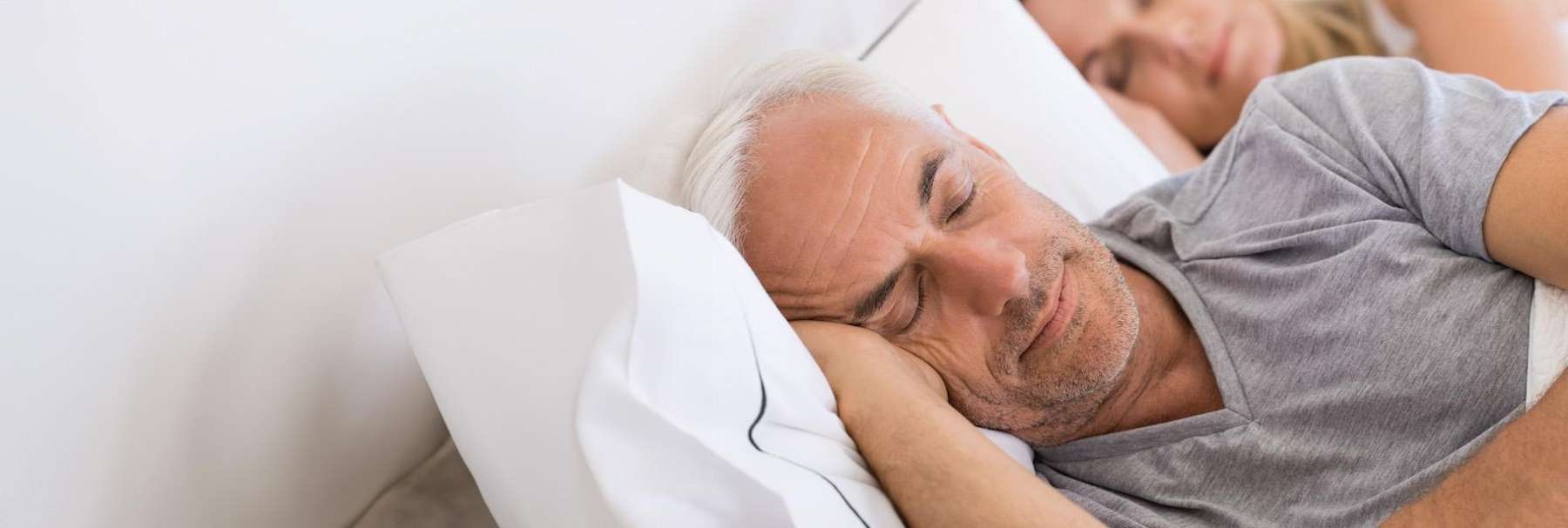 man sleeping after sleep apnea treatment