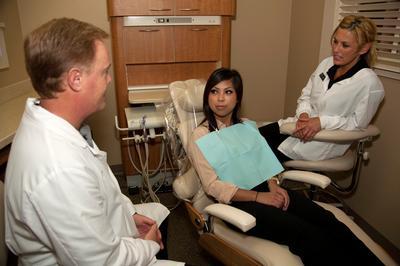 Attentive Care from Our Irvine Team Dr. Robertson with patient | dentist irvine ca